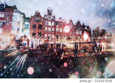 Beautiful calm night view of Amsterdam city during a snowstorm. Bokeh light effect, soft filter 122827836