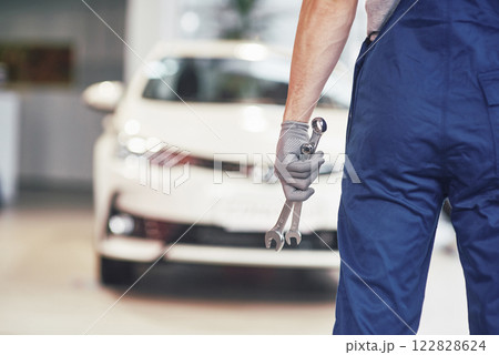 Hands of car mechanic with wrench in garage Hands of car mechanic with wrench in garage 122828624