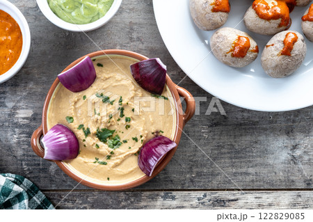 Papas arrugadas with mojo and gofio escaldado on wooden table. Traditional Canary Islands food. 122829085