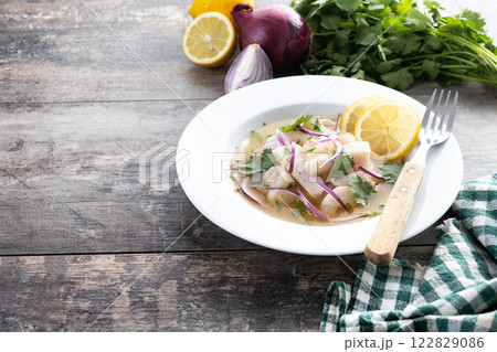 Traditional Peruvian ceviche sea bass fillet on wooden table 122829086