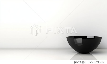 Black bowl on bright surface 122829307