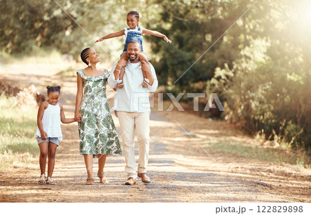Happy black family bonding on an outdoor work in a park, loving and having fun together. African American parents enjoying fresh air and an active walk with their children, playful, cheerful and free 122829898