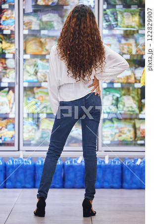 Grocery, store and supermarket with a woman customer shopping for food and groceries in a fresh produce aisle. Shopper, hungry and retail with a female consumer looking at products in a shop fridge Grocery, store and supermarket with a woman customer shopping for food and groceries in a fresh produce aisle. Shopper, hungry and retail with a female consumer looking at products in a shop fridge 122829907
