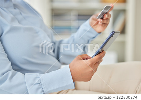 Business woman online shopping with a credit card and phone while on a break in corporate office. Closeup of a girl paying her mortgage, debt or financial bills with internet banking on a smartphone. 122830274