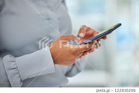 Phone, hands and communication with a business woman networking with wifi technology in her office at work. Closeup of a female employee reading, typing or sending a text message on her mobile 122830298