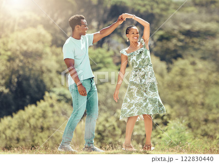 Love, freedom and celebration by couple dancing outdoors, loving romantic getaway and bonding. Happy black man and woman being playful and sweet, enjoying their relationship and having fun together Love, freedom and celebration by couple dancing outdoors, loving romantic getaway and bonding. Happy black man and woman being playful and sweet, enjoying their relationship and having fun together 122830440