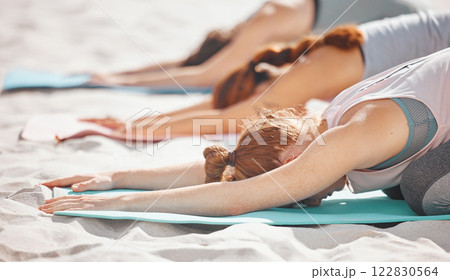 Beach yoga, fitness women and balasana stretching, kneeling and balance in extended childs pose. Exercise, peace and healthy workout for energy, mind wellness and zen training on summer sand seashore 122830564