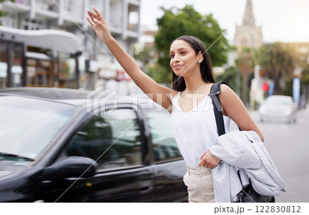 Business woman call a taxi or transport in the city street in the morning while commute to work. Friendly corporate worker hand and arm wave for a cab in a urban town and road in busy traffic Business woman call a taxi or transport in the city street in the morning while commute to work. Friendly corporate worker hand and arm wave for a cab in a urban town and road in busy traffic 122830812