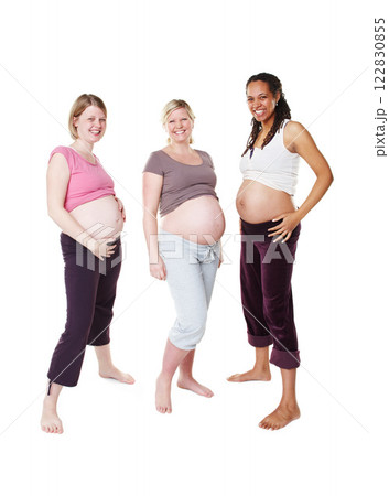 Portrait of happy pregnant, woman and friends in a group photo over white studio background. Female people in diversity smile with baby bumps or belly standing in happiness to be a mother in mockup. Portrait of happy pregnant, woman and friends in a group photo over white studio background. Female people in diversity smile with baby bumps or belly standing in happiness to be a mother in mockup. 122830855