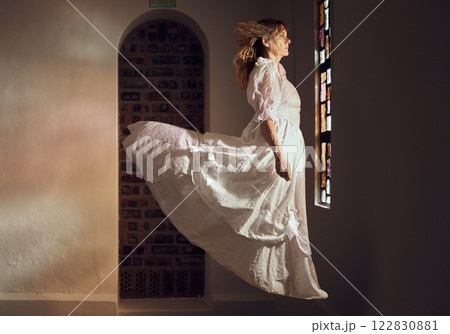 Ghost of senior woman, looking at stained glass and floating over floor of building or cathedral. Elderly soul, phantom or dead spirit staring at beautiful window at a chapel or church after funeral 122830881