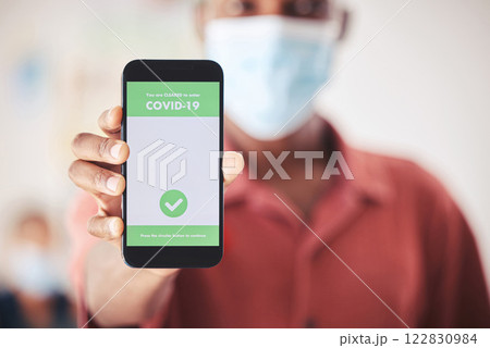 Covid, QR code and phone in person hand for vaccinated digital verification certificate or passport at an airport, hospital or clinic. Man with smartphone and screen technology for coronavirus safety Covid, QR code and phone in person hand for vaccinated digital verification certificate or passport at an airport, hospital or clinic. Man with smartphone and screen technology for coronavirus safety 122830984