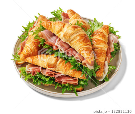 croissant sandwiches with ham and lettuce on plate 122831130