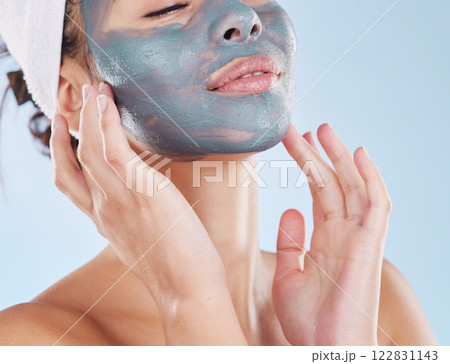 Skincare, facial and beauty with woman with face mask for cosmetics luxury, relax or acne against blue background studio. Salon, product and dermatology for wellness, spa and treatment 122831143