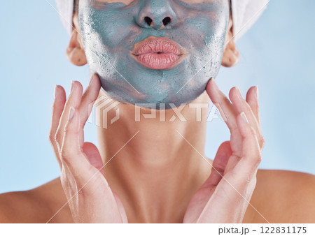 Skincare wellness, charcoal face mask and beauty product for healthy skin against blue mockup studio background. Model pouting mouth, care for body and natural cosmetic treatment for wellbeing 122831175