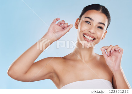 Oral, dental and flossing woman cleaning teeth in a studio blue background mockup. Young model with white or perfect smile, clean mouth or gums portrait for hygiene, healthcare and dentistry mock up Oral, dental and flossing woman cleaning teeth in a studio blue background mockup. Young model with white or perfect smile, clean mouth or gums portrait for hygiene, healthcare and dentistry mock up 122831232