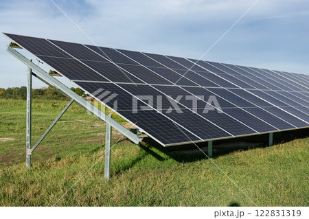 Solar panels providing clean energy under a cloudy sky Solar panels providing clean energy under a cloudy sky 122831319