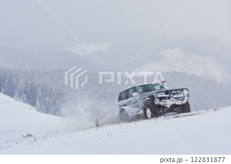 SUV rides on a winter mountians driving risk of snow and ice, drifting SUV rides on a winter mountians driving risk of snow and ice, drifting 122831877