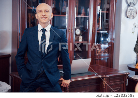 Confident handsome businessman sitting in luxury interior 122832588