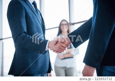 Two confident business man shaking hands during a meeting in the office, success, dealing, greeting and partner concept Two confident business man shaking hands during a meeting in the office, success, dealing, greeting and partner concept 122832712
