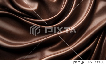 Piece of fabric with a brown color and a shiny texture. The fabric is folded and has a smooth surface 122833914