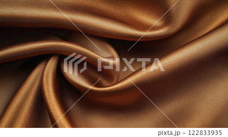 Piece of brown fabric with a pattern on it. The fabric is rolled up and has a shiny texture 122833935
