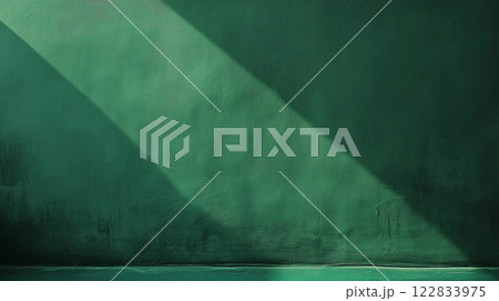 Green wall with a shadow on it. The shadow is on the wall and it is very dark Green wall with a shadow on it. The shadow is on the wall and it is very dark 122833975