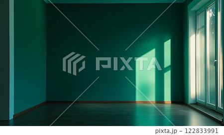 Large empty room with a green wall and a window. The room is very bright and open, with a lot of natural light coming in through the window Large empty room with a green wall and a window. The room is very bright and open, with a lot of natural light coming in through the window 122833991