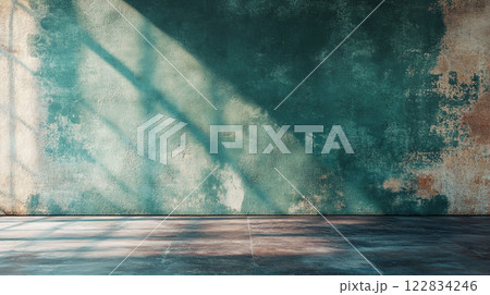 Large wall with a green color and a shadow on it. The wall is empty and has a lot of texture 122834246