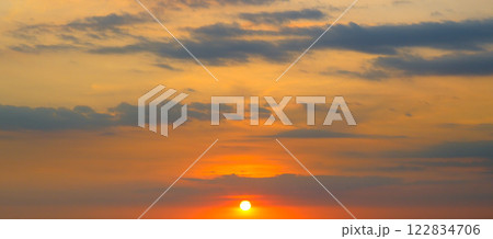 Cloudy sky and bright sunrise over the horizon. 122834706