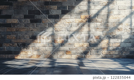 Brick wall with a window in the middle. The wall is empty and the window is letting in sunlight 122835044