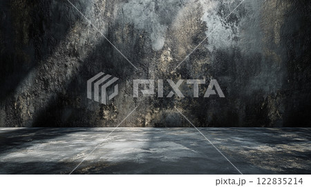 Dark room with a wall covered in graffiti and a large empty space. The room is dimly lit, with only a few rays of light shining through the cracks in the wall. Scene is one of emptiness and decay 122835214