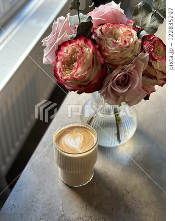 L.atte art tulip flower beautiful. Coffee cup cappuccino and a bouquet of flowers. Hygge lifestyle, cozy mood. Coffee, flower in back light. L.atte art tulip flower beautiful. Coffee cup cappuccino and a bouquet of flowers. Hygge lifestyle, cozy mood. Coffee, flower in back light. 122835297