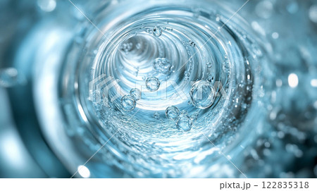 Water pipe with bubbles in it. The bubbles are small and scattered throughout the pipe. The water is clear and the bubbles are floating on top of it 122835318