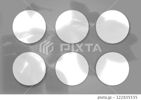 Natural light casts shadows from the plant on 4 round sheets of white textured paper lying on a grey textured background. Mockup Natural light casts shadows from the plant on 4 round sheets of white textured paper lying on a grey textured background. Mockup 122835535