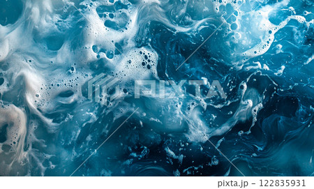 The image is of a large body of water with foam and bubbles. The water appears to be a mix of blue and white, creating a calming and serene atmosphere. The foam and bubbles add a sense of movement 122835931