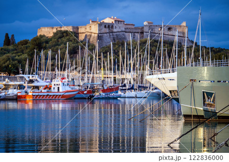 Antibes castle and port with boats and tower over blue sky Antibes castle and port with boats and tower over blue sky 122836000