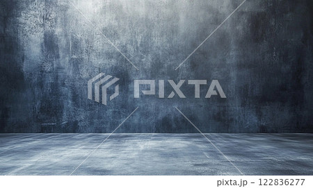 Large, empty room with a grey wall. The room is bare and empty, with no furniture or decorations. The grey wall gives the room a cold, sterile feel 122836277