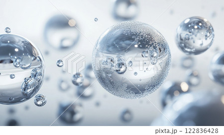 Series of small, clear bubbles floating in the air. The bubbles are scattered throughout the scene, with some closer to the foreground and others further in the background. Scene is one of lightness 122836428