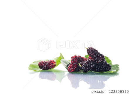 ripe black mulberry berries with leaves, isolated on white background ripe black mulberry berries with leaves, isolated on white background 122836539