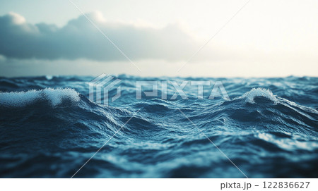 The ocean is calm and peaceful, with a few small waves breaking on the shore. The sky is cloudy, but the water is still and clear The ocean is calm and peaceful, with a few small waves breaking on the shore. The sky is cloudy, but the water is still and clear 122836627