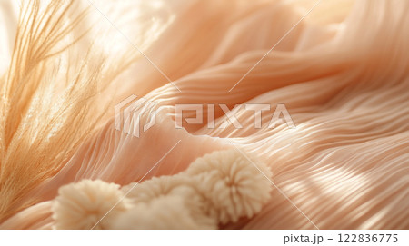 Piece of fabric with a pattern of white and tan swirls. There are also white pom poms on the fabric 122836775