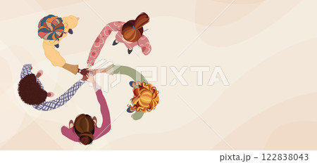 Top view of a diverse group of female colleagues in a circle hands stacked together as a symbol of agreement or unity.International women s day.DEIB or empowerment.Banner copy space 122838043