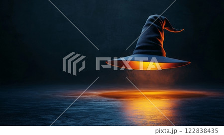 A mystical witch hat floats in darkness, illuminated from below, creating an enchanting and magical atmosphere. 122838435