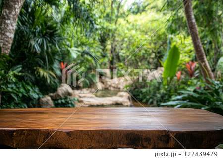 Scenic wooden table overlooking lush green hills under a cloudy sky in a natural setting 122839429