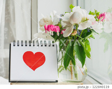 Bouquet of bright flowers standing in a vase 122840119