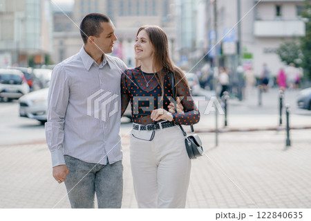 Two tourists having fun on romantic summer vacation in Poland - Holidays and traveling lifestyle concept. Young couple walking street on vacation. Happy couple of travelers enjoying. 122840635