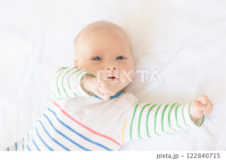 Little baby on white bed 122840715