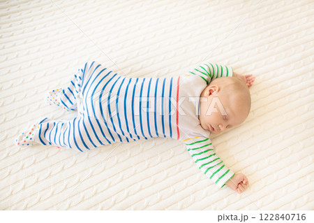 Little baby on white bed Little baby on white bed 122840716