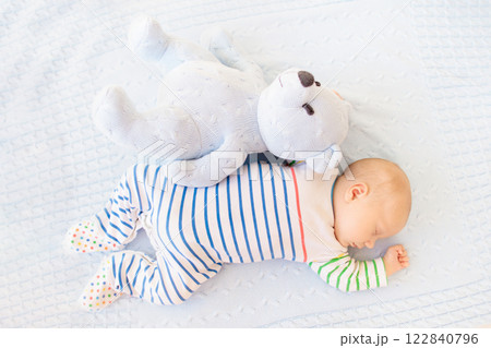 Little baby on white bed 122840796