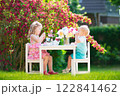 Kids having fun at garden tea party 122841462